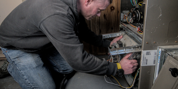 Walboldt HVAC technician conducting annual furnace maintenance for a customer