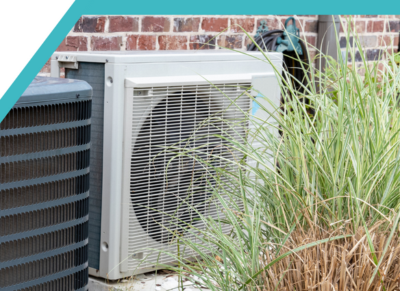 White Heat Pump Outside Home White heat pump outside brick home in backyard